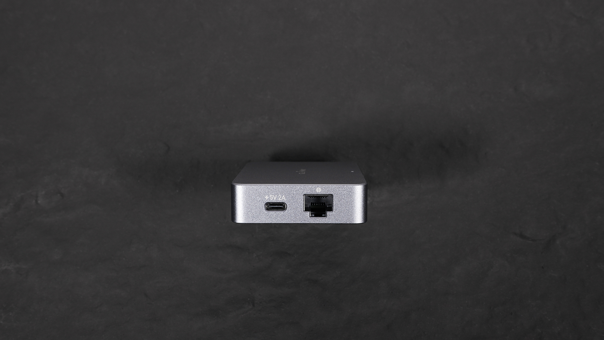 Close-up of the right side of the GL.iNet Comet (GL-RM1) KVM device showing the USB-C power port and Ethernet port.